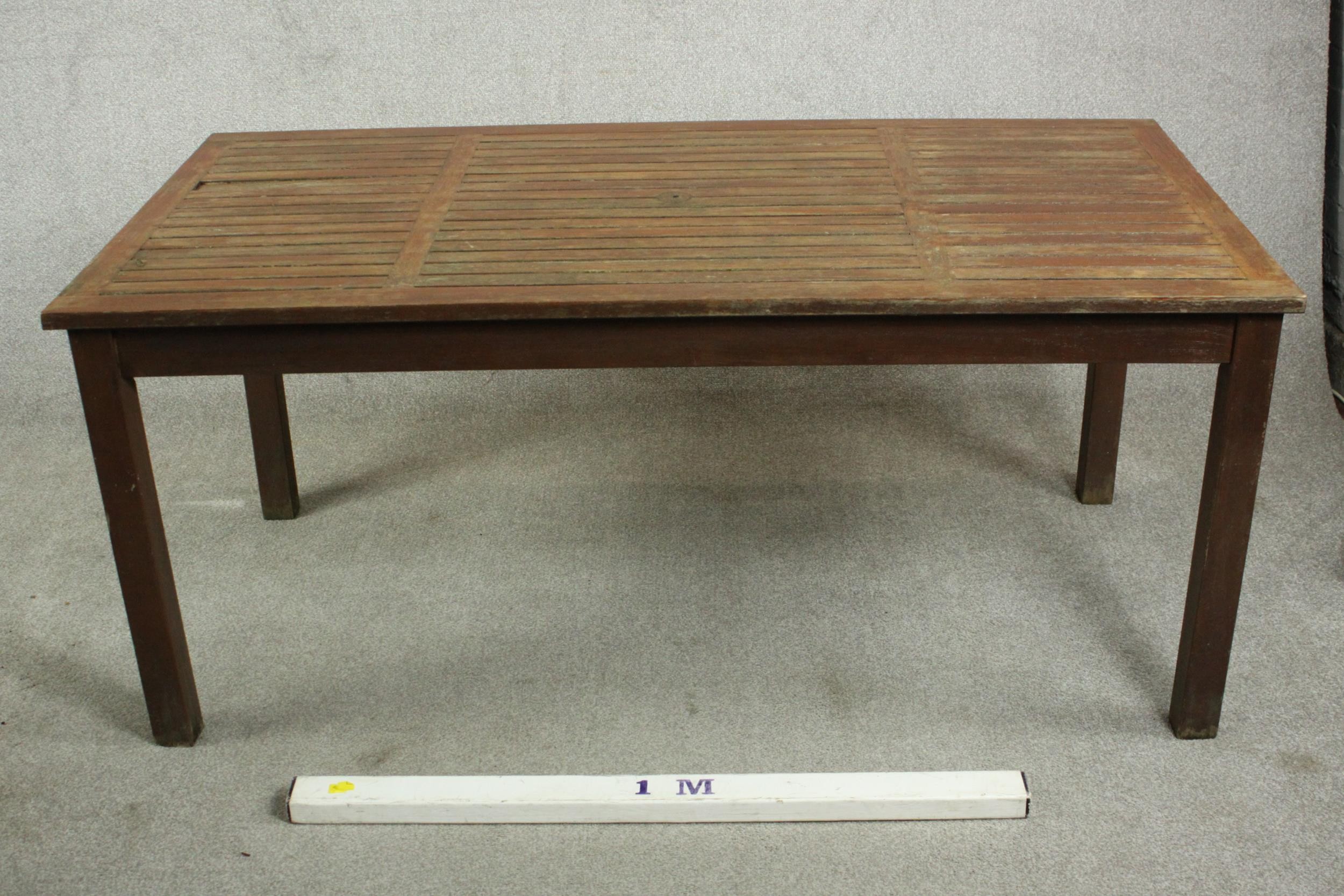 A contemporary teak garden dining table, with a rectangular slatted top on square section legs. H.69 - Image 2 of 4