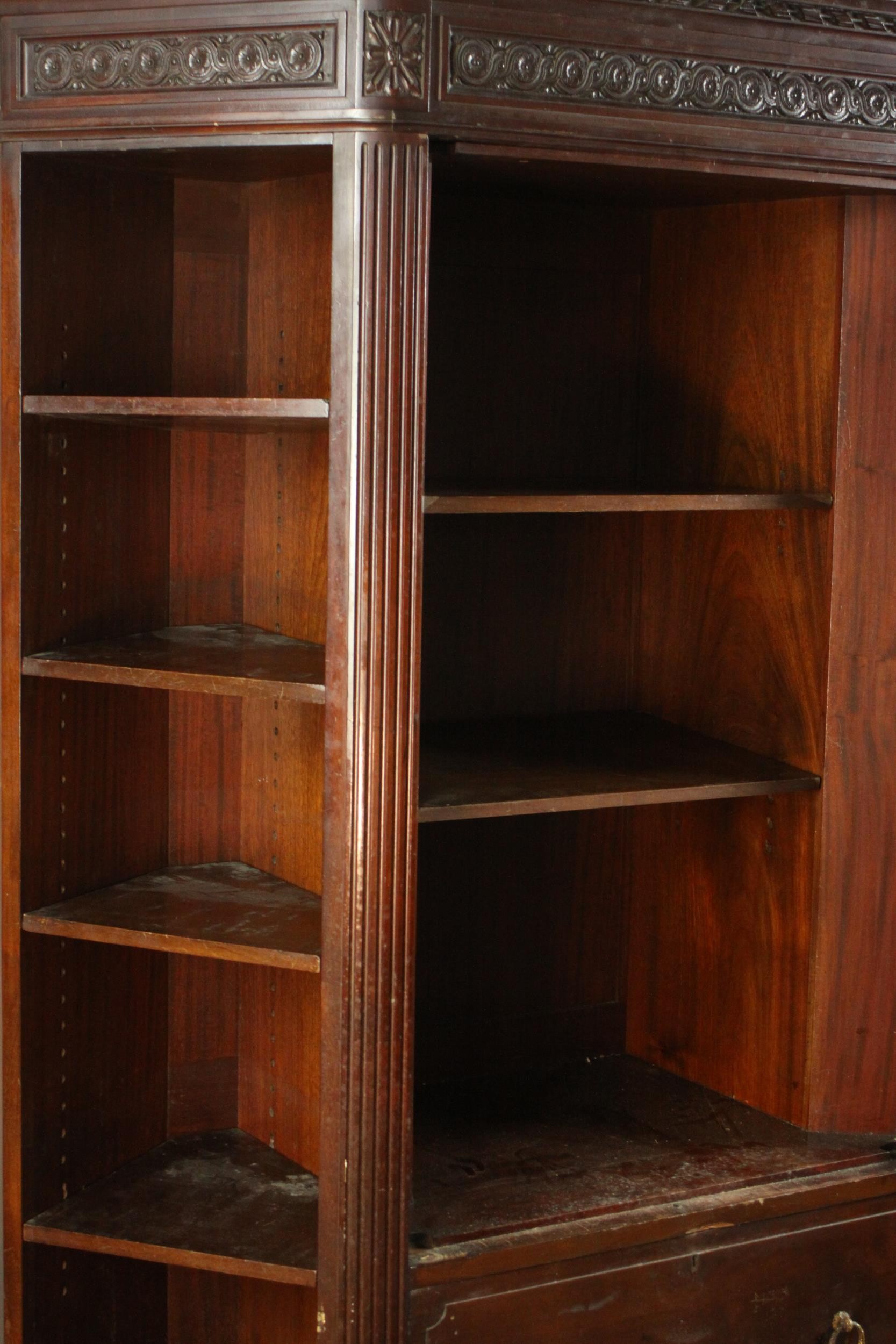 A Continental walnut bookcase with open shelves above drawers on tapering reeded supports. (back - Image 5 of 9