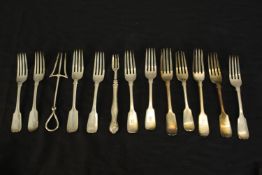 A collection of thirteen silver forks, including a silver crumpet fork, a silver pickle fork,