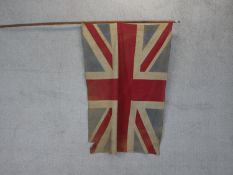 An early 20th century canvas Union Jack mounted on a pole. L.250cm