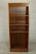 A contemporary open bookcase, with three adjustable shelves on a plinth base. H.158 W.61 D.30.5cm.