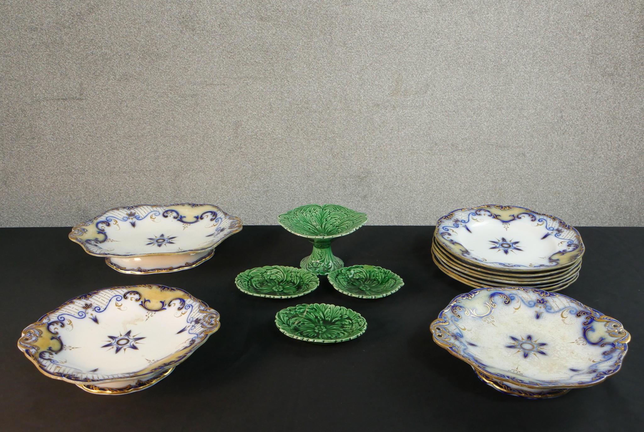Three 19th century green glaze majolica leaf design plates along with a comport and a collection