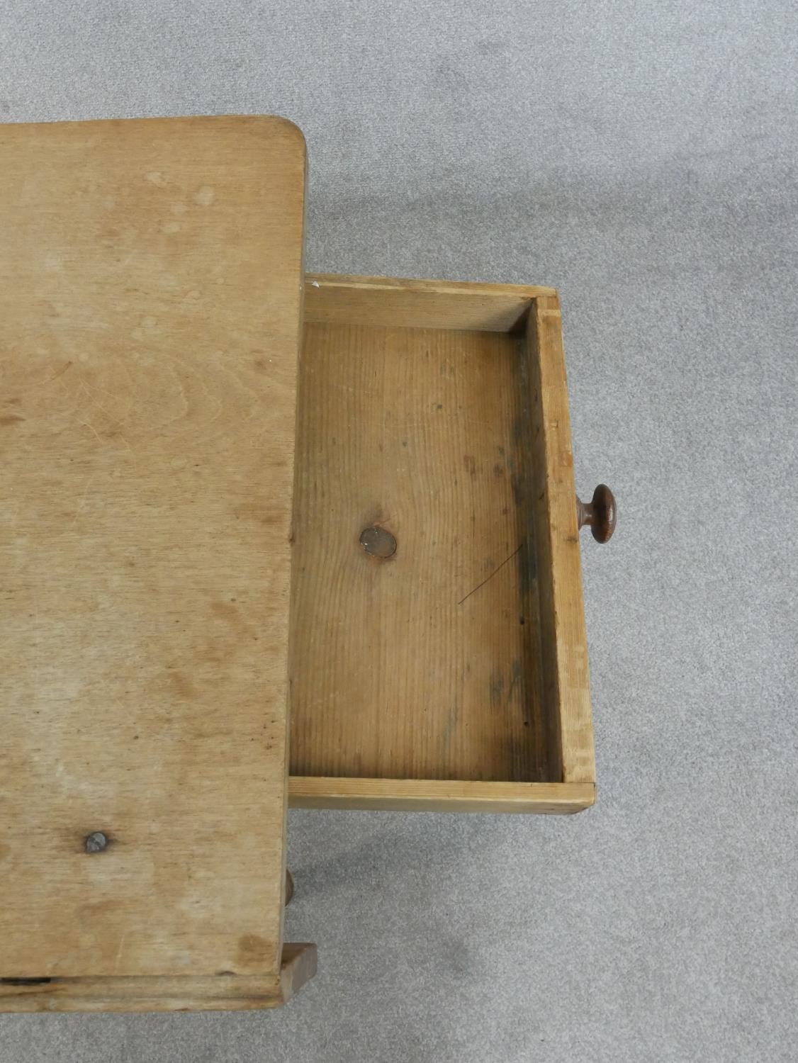 A Victorian pine kitchen table, with one drop leaf over end drawers, on turned legs. H.71 W.109 - Image 5 of 7