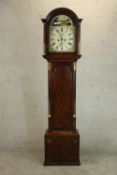 A George III flame mahogany longcase clock, the hood of rounded arch form flanked by columns, the