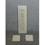 A decorative plaster panel with urn and putti design along with two smaller plaster relief plaques