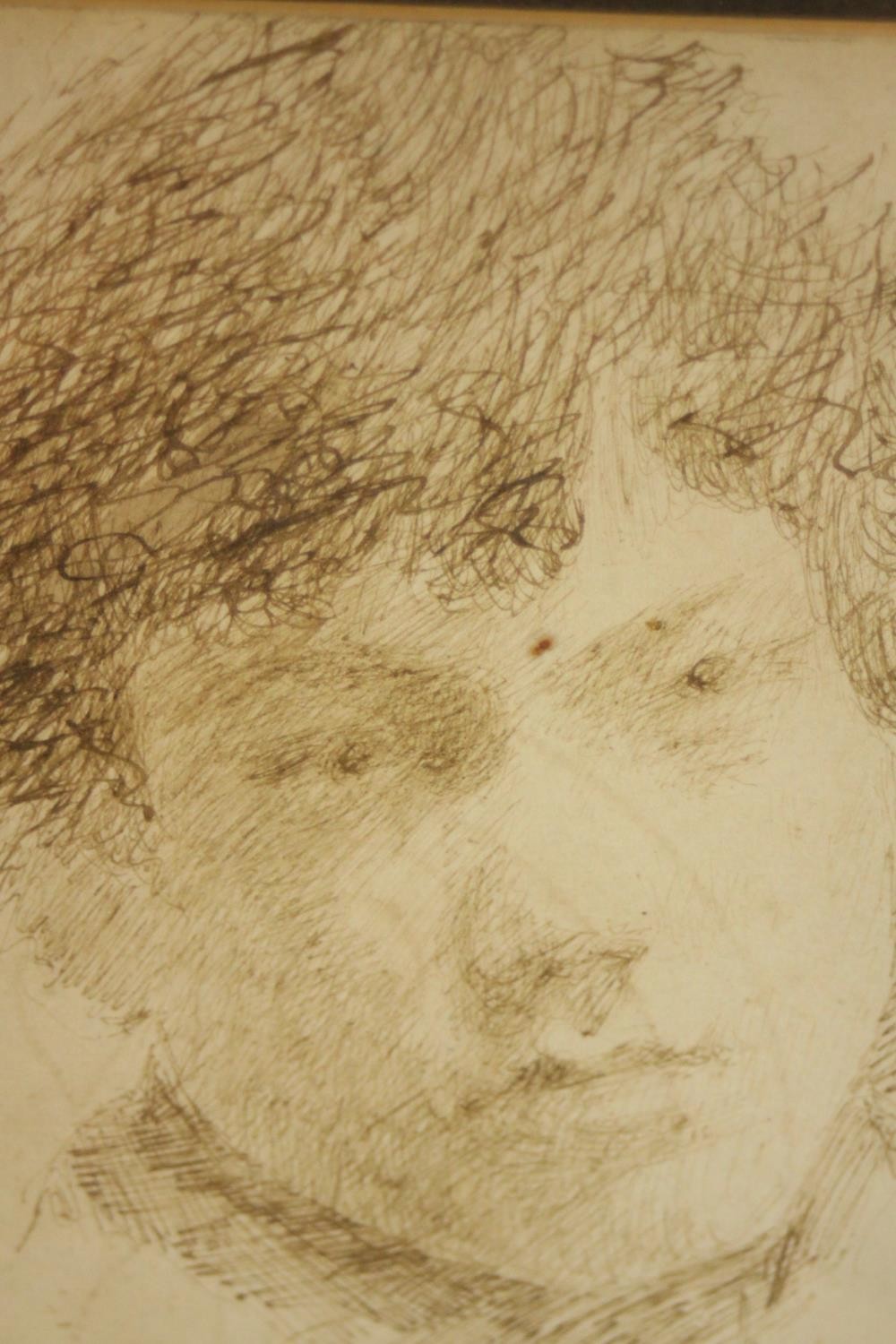 A framed and glazed pen drawing of a young boy, unsigned. H.20 W.17cm.