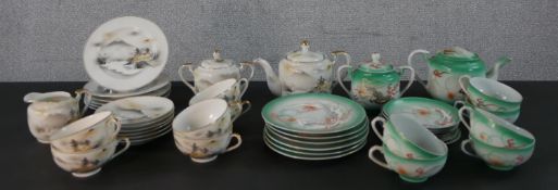 Two Japanese six person porcelain tea sets, one with relief dragon design and the other with a
