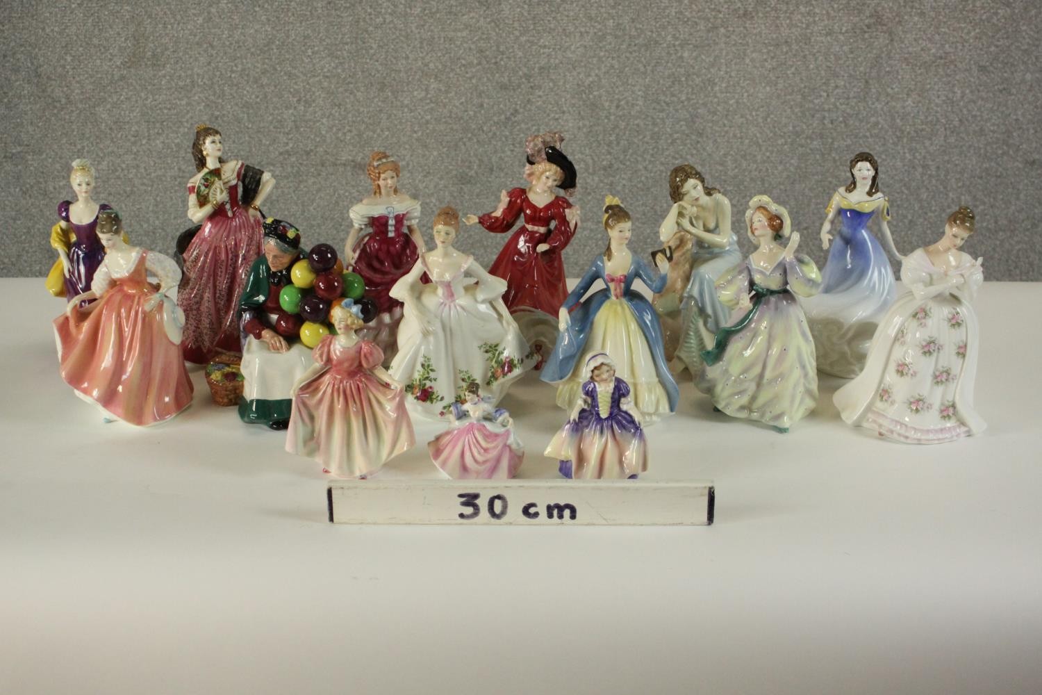 A collection of fifteen hand painted porcelain figures of ladies in a variety of coloured outfits by - Image 2 of 27
