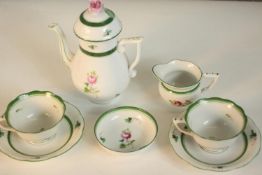 A Herend porcelain tea set for two, decorated with hand painted pink roses and green borders,