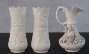 A pair of Belleek vases, with flared rims and moulded decoration along with a Belleek jug, with a