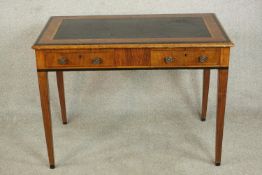 A late Victorian figured walnut writing table, the top with a black leather writing insert with a