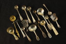 A collection of sixteen pieces of 19th century silver cutlery, including two Georgian caddy spoons