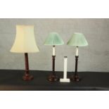 A pair of mahogany candlestick design table lamps with green silk shades along with another