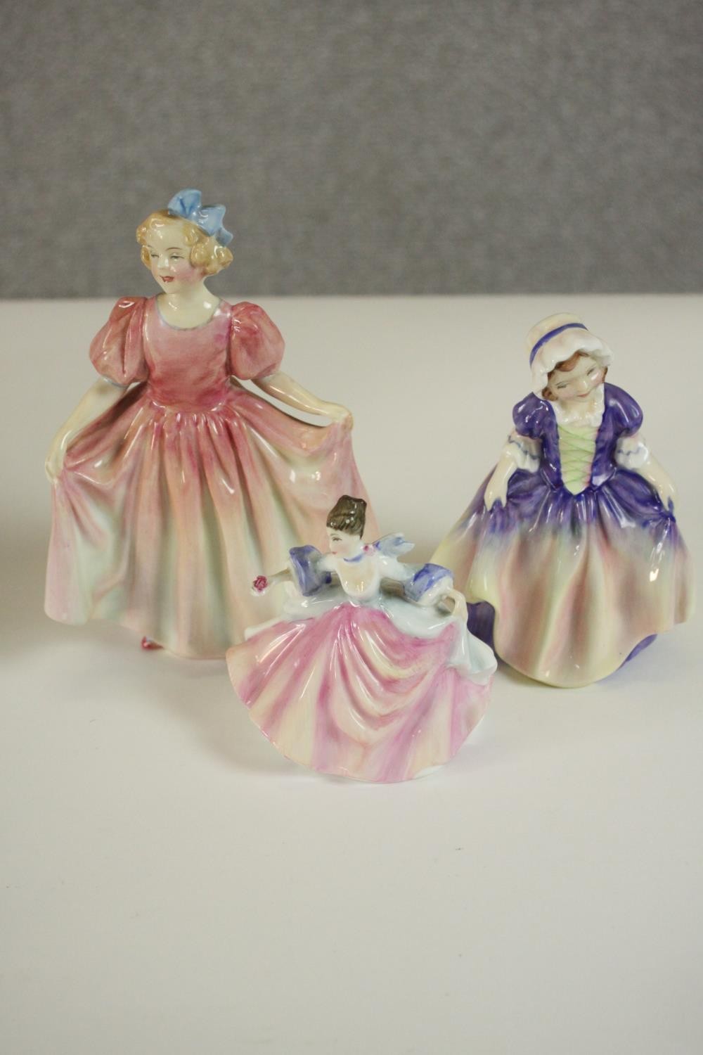 A collection of fifteen hand painted porcelain figures of ladies in a variety of coloured outfits by - Image 3 of 27