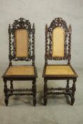 A near pair of Victorian Carolean style oak side chairs, with caned back and seat, the ornately