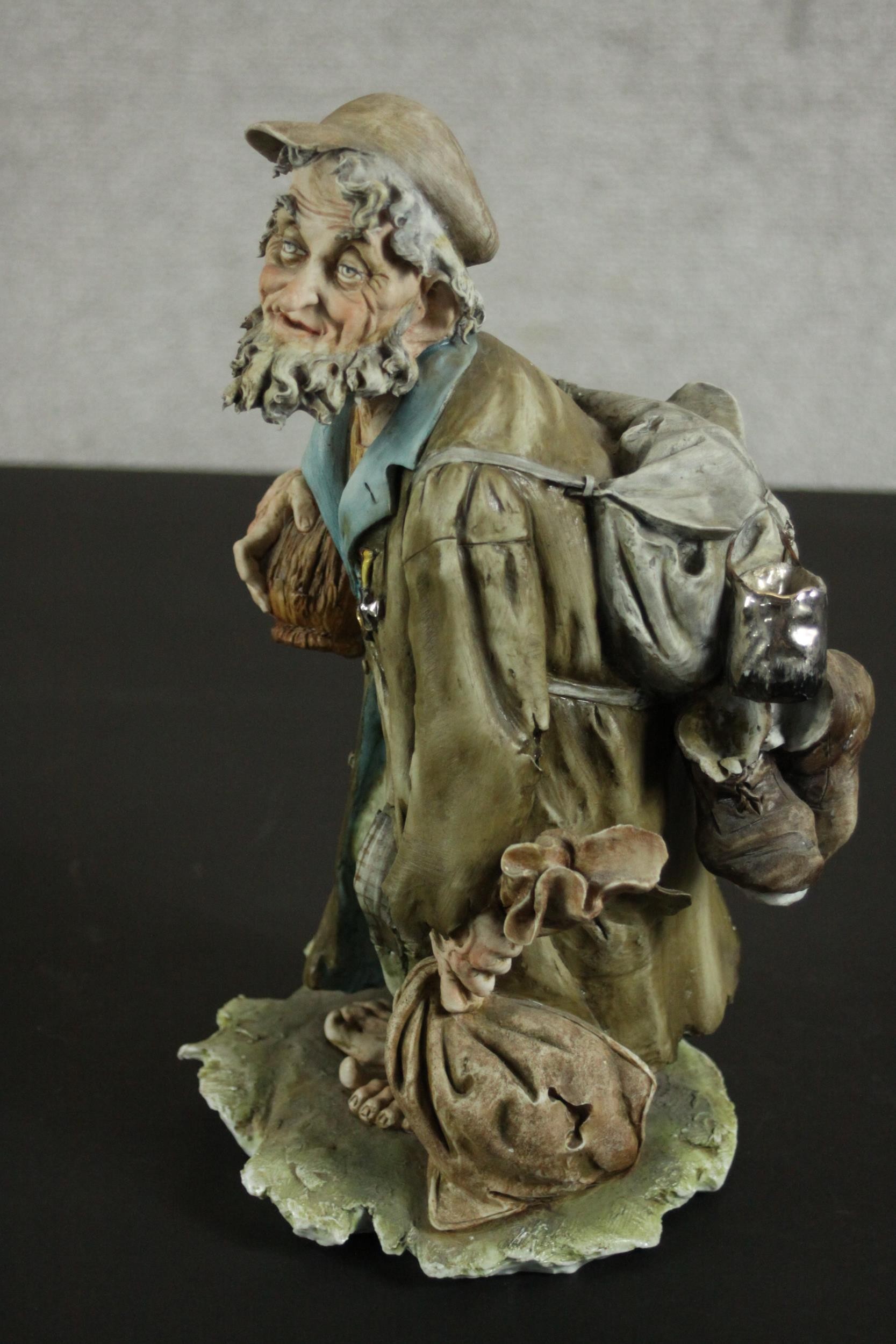 An Italian Capo di Monte barefoot tramp figure on a naturalistic base. H.27 W.15 D.14cm. - Image 3 of 9
