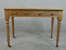 A Victorian pine side table, with two short frieze drawers on turned legs. H.66 W.105 D.54cm