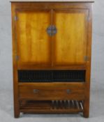 A late 20th century Chinese hardwood television or HiFi cabinet, with two cupboard doors over