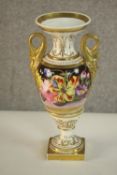 A 19th century hand painted porcelain urn with gilded dolphin form handles and hand painted with a