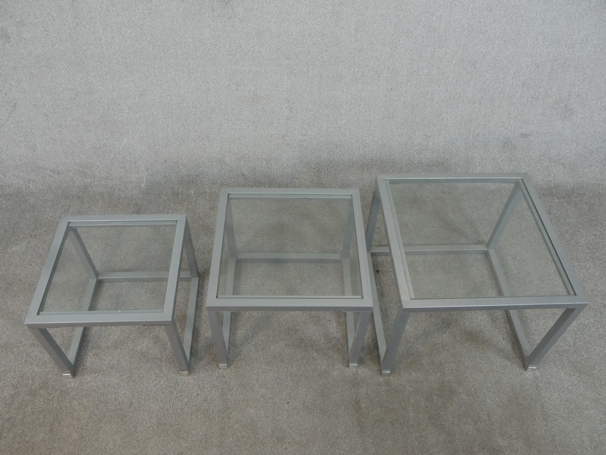 A contemporary nest of three occasional tables, of square form with plate glass tops and square - Image 3 of 3