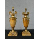 A pair of 19th century Empire style yellow marble and gilt spelter amphora design table lamps with