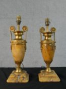 A pair of 19th century Empire style yellow marble and gilt spelter amphora design table lamps with