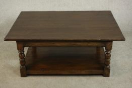 A 17th century style stained oak coffee table, the rectangular top on turned and block legs joined