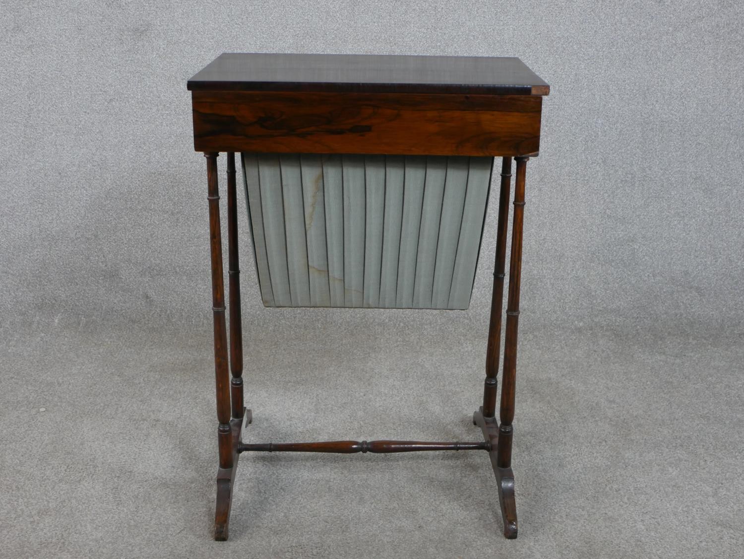 A 19th century rosewood work table, with a rectangular rising lid and fitted interior, over a