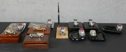 A selection of mounted vintage car ceramic and chrome ashtrays, marquetry boxes & pen holders,