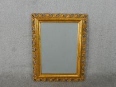 An early 20th century giltwood rectangular wall mirror, with a rectangular bevelled mirror plate,