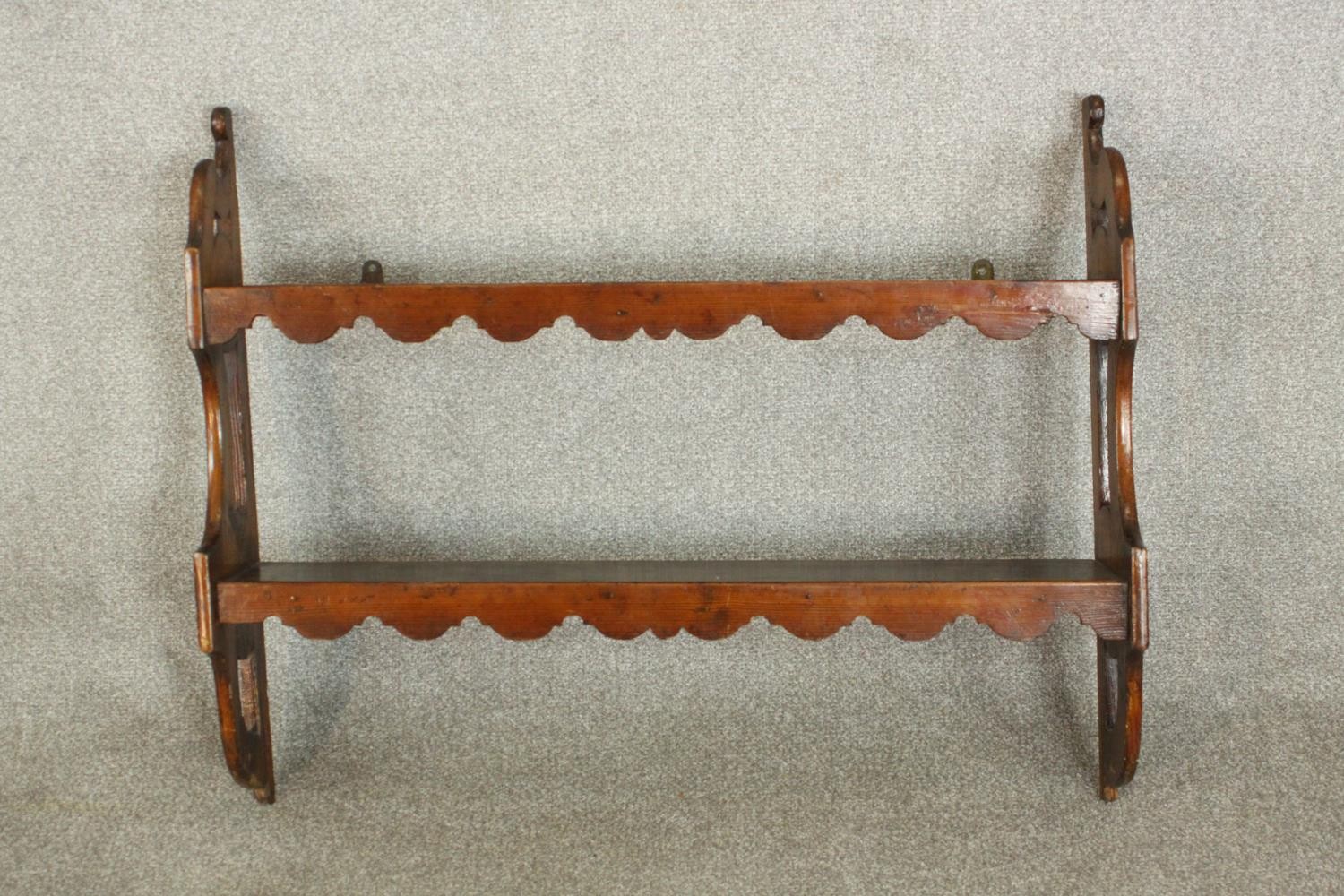 A set of 19th century pine wall shelves, the two shelves with undulating fronts, the sides with