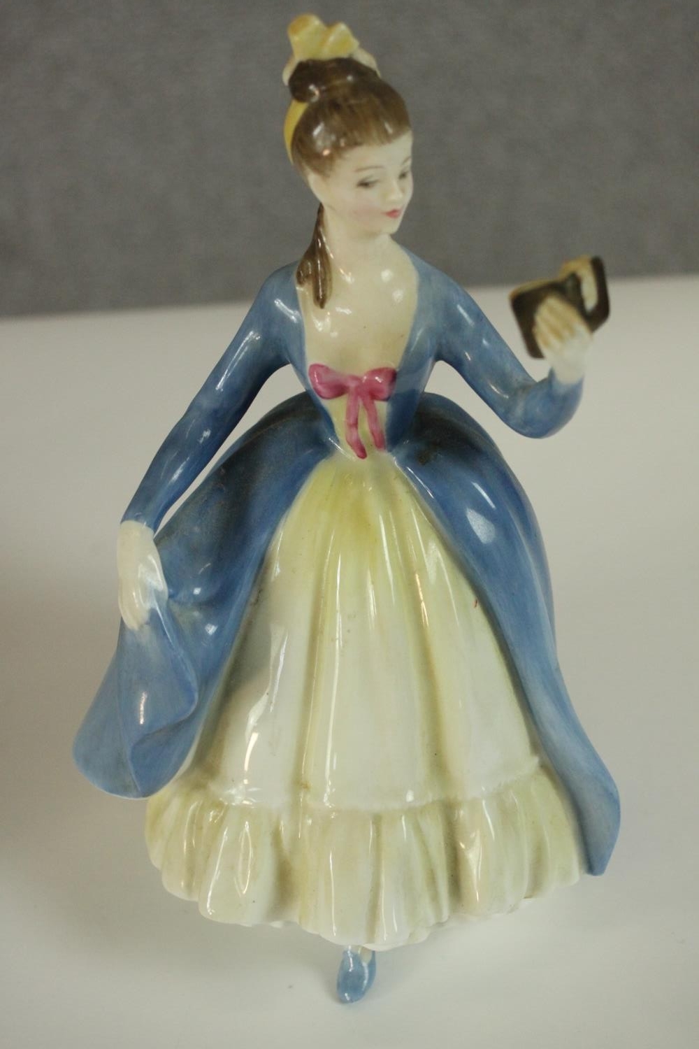 A collection of fifteen hand painted porcelain figures of ladies in a variety of coloured outfits by - Image 7 of 27