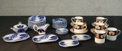 A six person part Royal Albert coffee set with gilded floral design along with a blue and white leaf