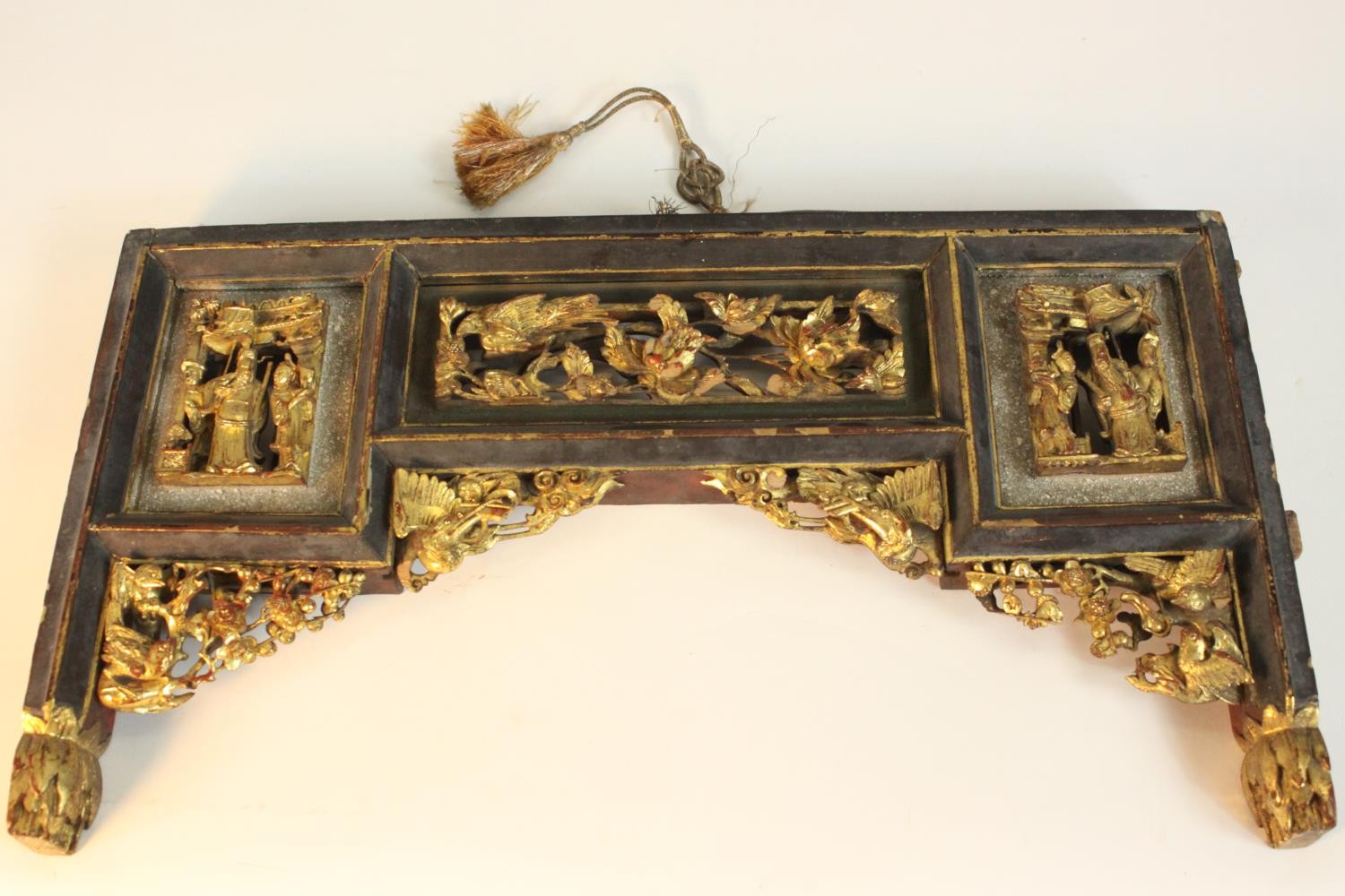 A Chinese furniture mount, set with carved and pierced giltwood panels, decorated with figures,