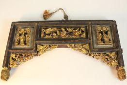 A Chinese furniture mount, set with carved and pierced giltwood panels, decorated with figures,