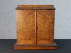 A late Victorian figured walnut and inlaid smoker's or collector's tabletop cabinet, with two