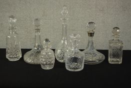 A collection of cut crystal and glass decanters, one with a silver collar. Hallmarked: S J Rose &