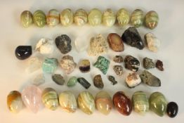 A collection of gemstones and minerals, including seventeen alabaster eggs, a rose quartz drop, iron