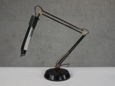 A black painted Herbert Terry style anglepoise desk lamp, with a rectangular shade and a circular