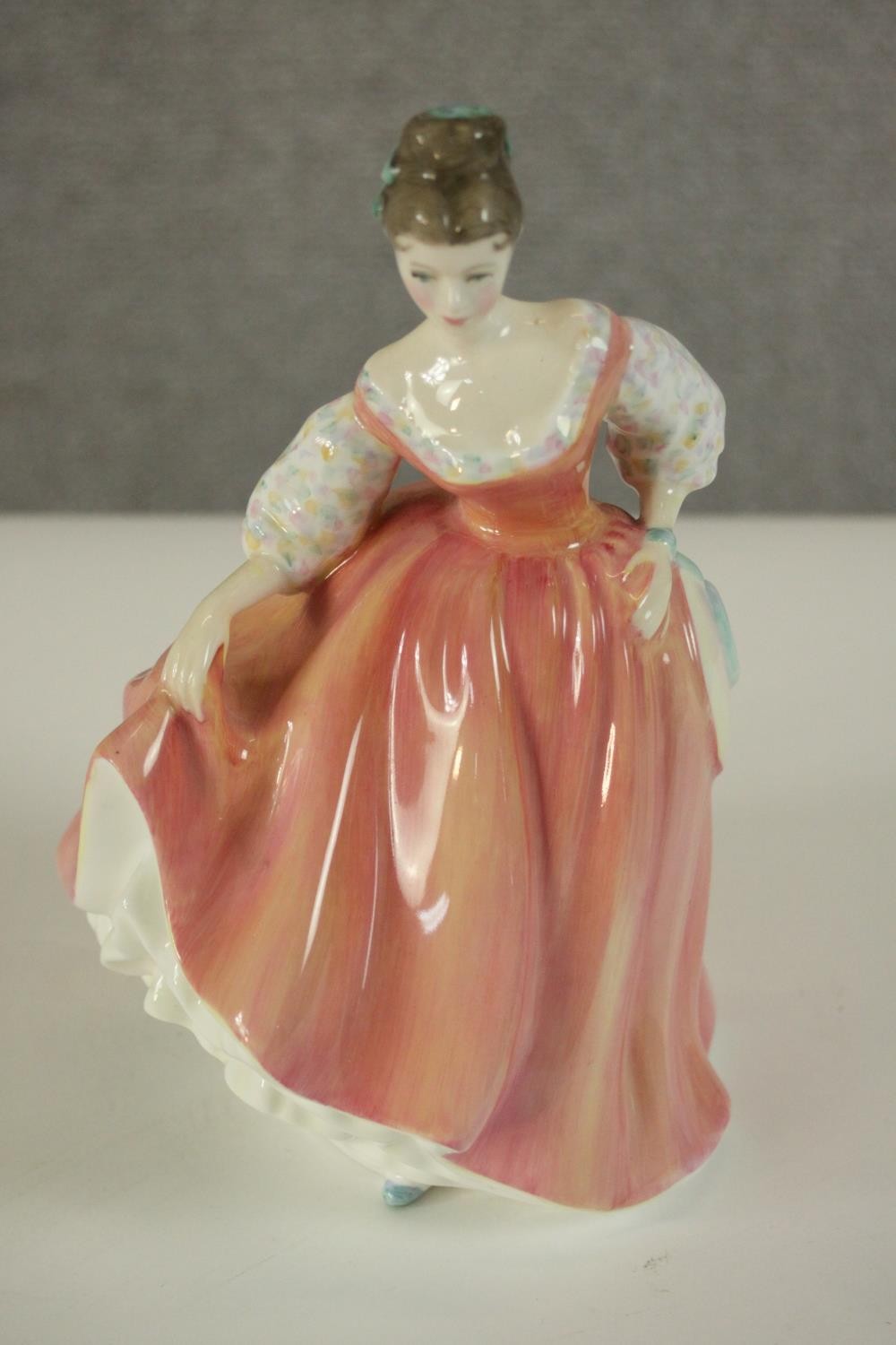 A collection of fifteen hand painted porcelain figures of ladies in a variety of coloured outfits by - Image 19 of 27
