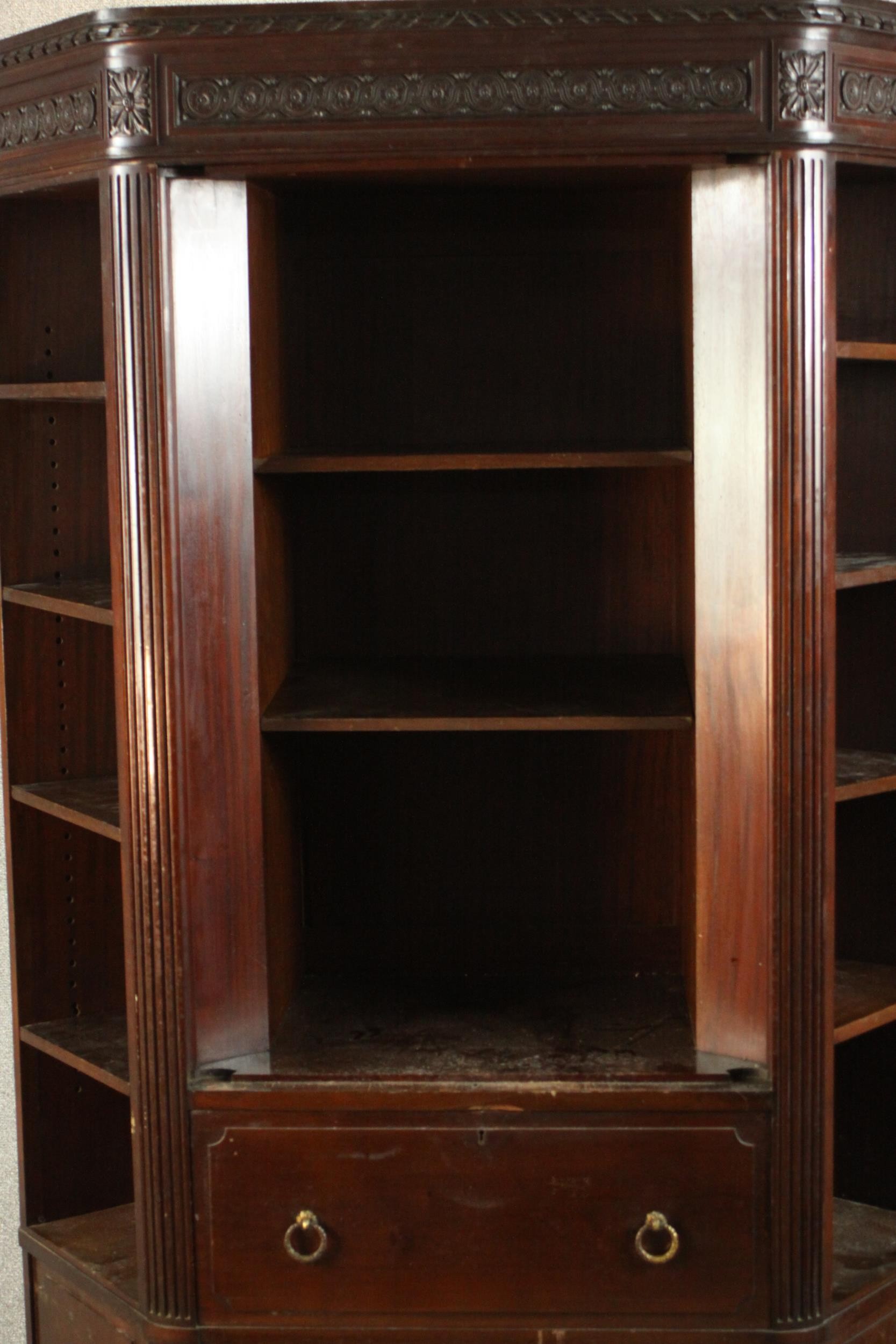 A Continental walnut bookcase with open shelves above drawers on tapering reeded supports. (back - Image 3 of 9