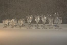A collection of twenty three cut crystal and glass drinking glasses, including a set of nine cristal