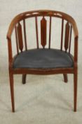 An Edwardian mahogany and inlaid tub chair, the serpentine fronted seat upholstered in dark grey
