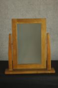 A late 20th century oak toilet mirror, with a rectangular mirror plate over a rectangular base. H.56