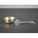 A pair of silver pierced vine design sugar tongs and a small silver bowl. 38g