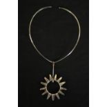 A boxed Norwegian silver collar necklace with abstract sun pendant. Hallmarked: JLM, Birmingham