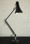 A mid 20th century Herbert Terry style anglepoise desk lamp, in black with a circular base. H.34