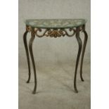 A contemporary gilt cast iron console table, of demi lune form with a plate glass top, the body