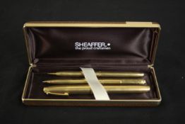 A cased set of vintage Schaefer rolled gold engraved linear design pens. Includes ball point pen,