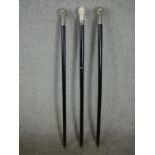 Three 20th century walking canes with skull head finials. H.97 W.4cm.